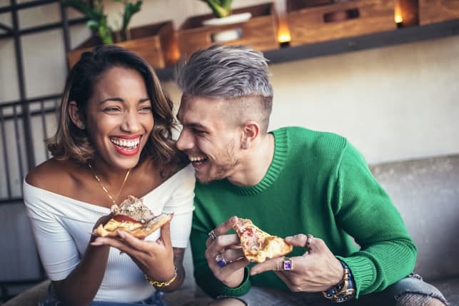 a happy interracial couple laughing and having fun together