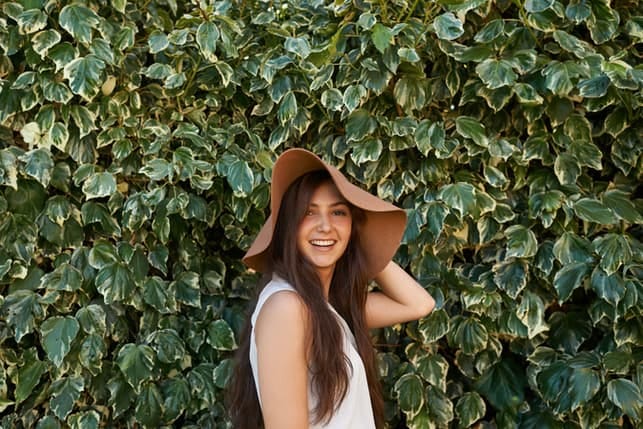 a portrait of a young happy girl in a hat