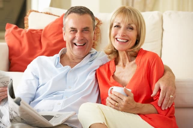 a mature couple in their 40’s posing and having fun at home