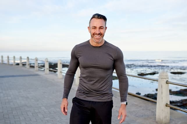a portrait of an adult sporty man on a walk