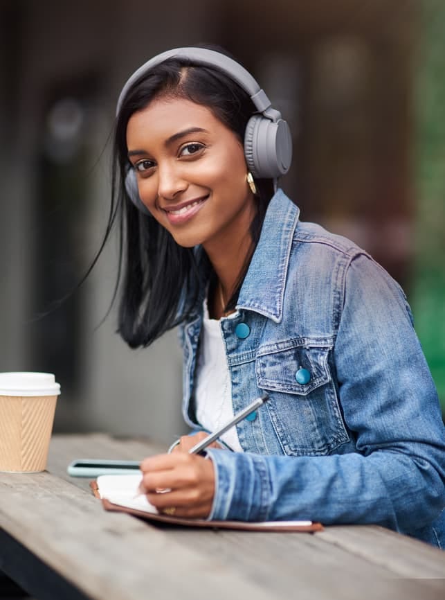 a modern Indian woman posing in headphones