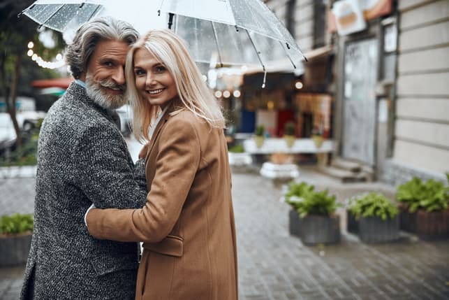 a mature couple having a date under an umbrella