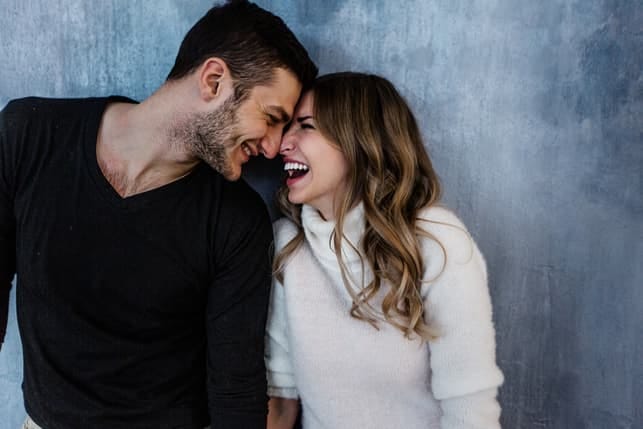 a beautiful couple is having fun and posing together