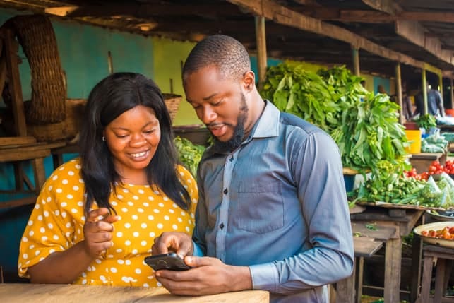 an african couple using a smartphone together