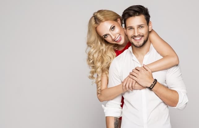 a young beautiful couple posing together