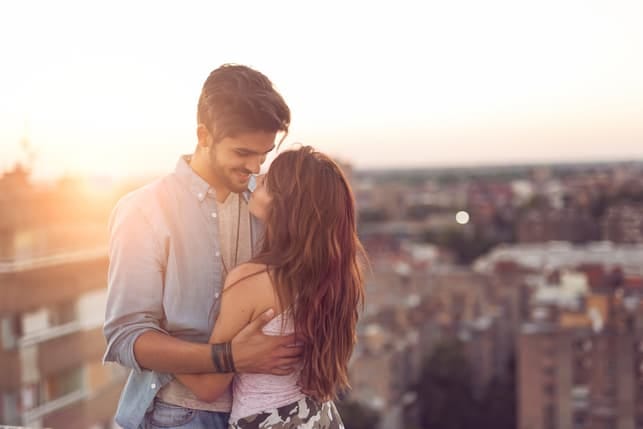 a couple hugging and enjoying each others company on a date