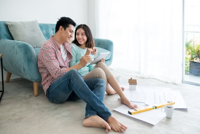 a cute asian couple relaxing at home