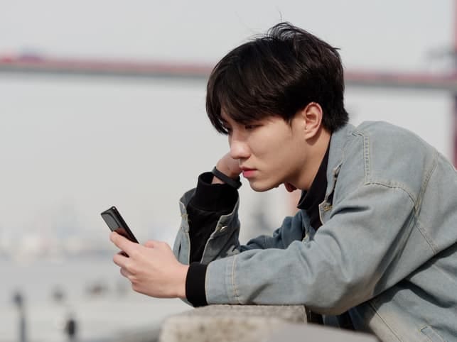 a young Asian man is sad because of his messages