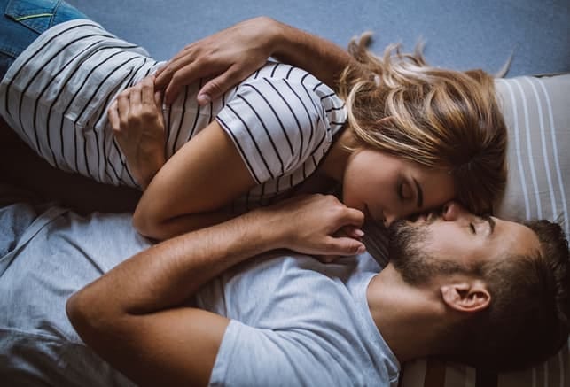 a couple sleeping while hugging together